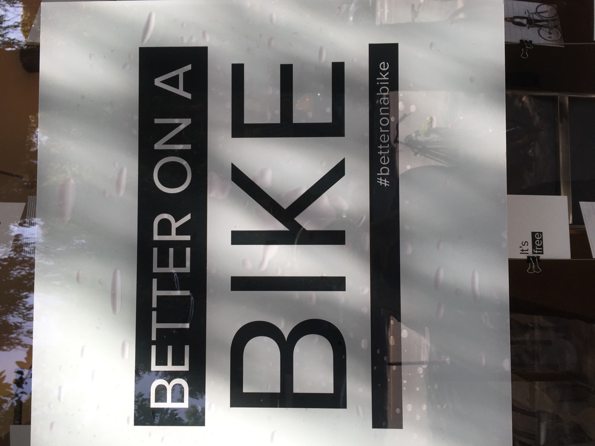 Window poster reading Better on a Bike