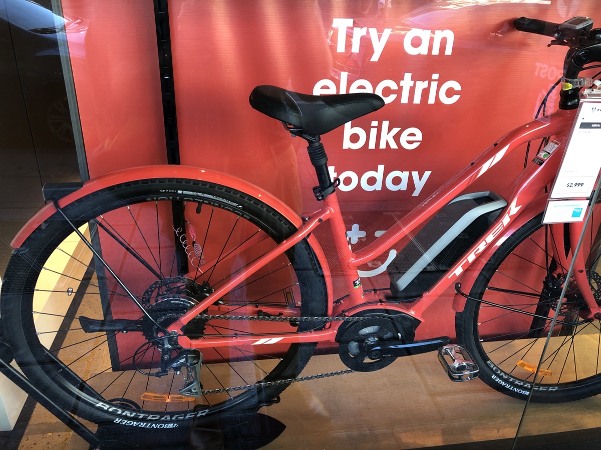 Red electric bike displayed in a shop window