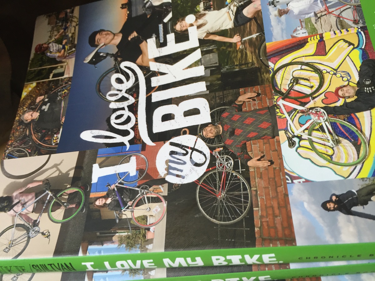 Wall collage with I love my bike lettering and cyclists