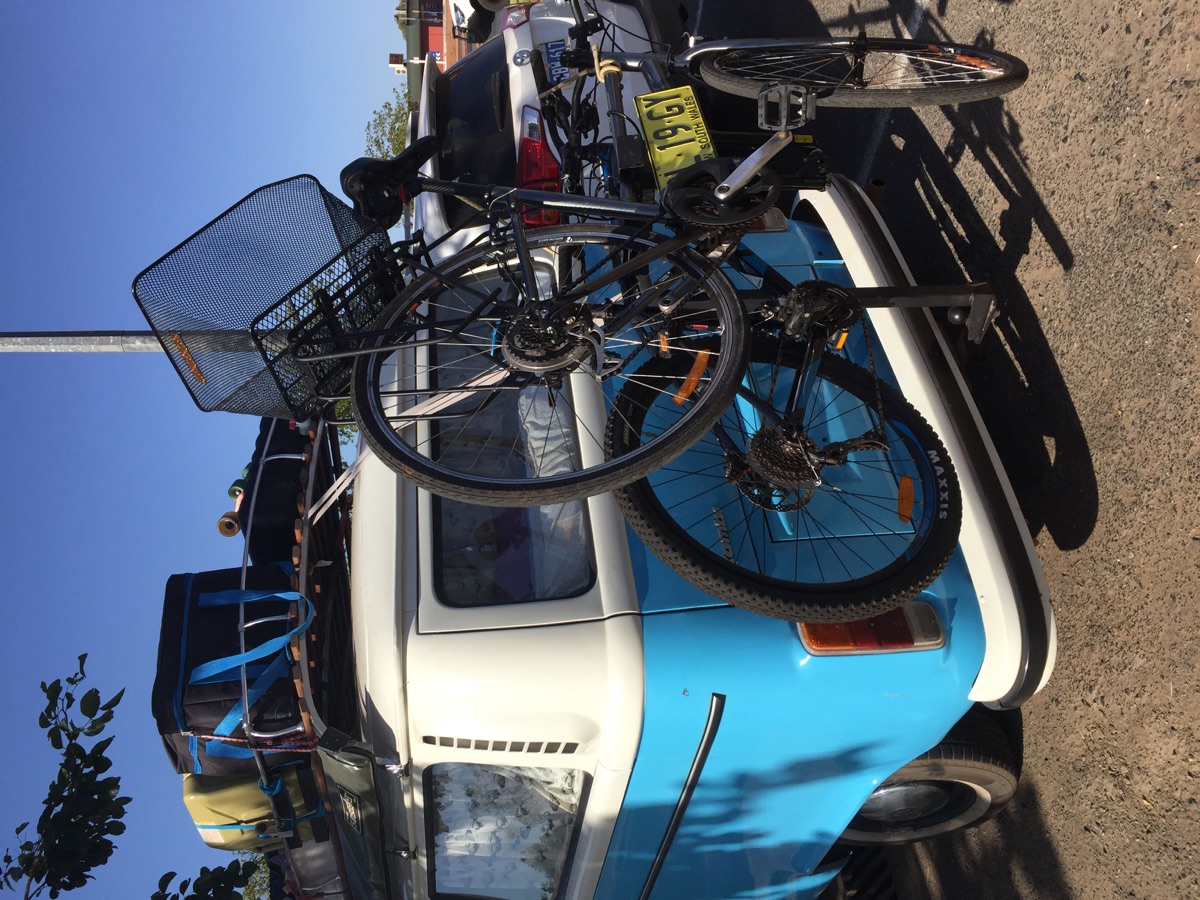 Bicycle mounted on a road-trip vehicle rack